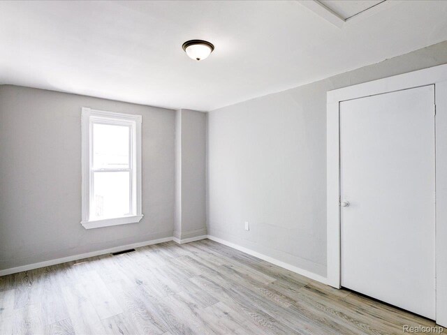 718 Superior St, Port Huron, MI 48060 - spare room featuring wood finished floors and baseboards