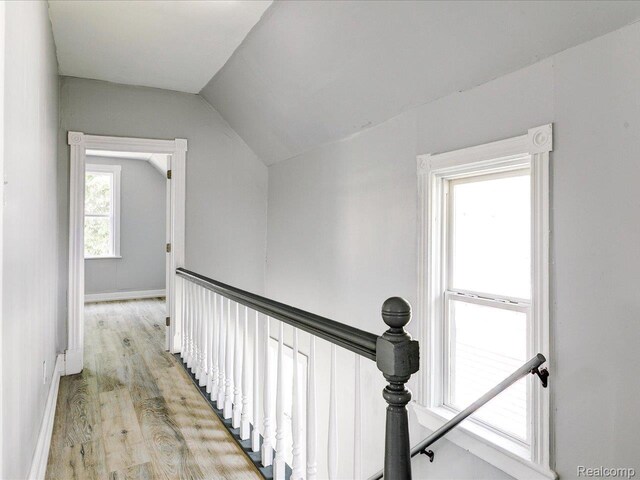 718 Superior St, Port Huron, MI 48060 - hall featuring lofted ceiling, light wood-type flooring, an upstairs landing, and baseboards