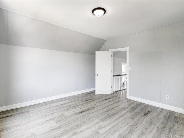 718 Superior St, Port Huron, MI 48060 - bonus room featuring wood finished floors, lofted ceiling, and baseboards