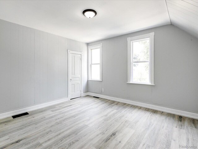 718 Superior St, Port Huron, MI 48060 - additional living space featuring light wood-style floors, vaulted ceiling, and baseboards