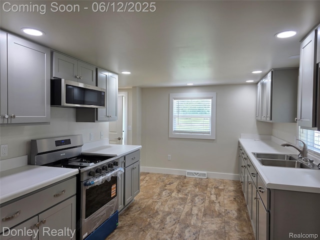 4514 Sebewaing Rd, Owendale, MI 48754 - kitchen featuring appliances with stainless steel finishes, a sink, gray cabinetry, light countertops, and recessed lighting