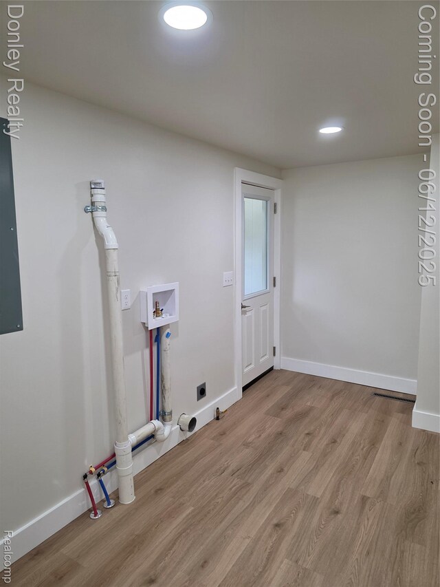 4514 Sebewaing Rd, Owendale, MI 48754 - washroom with electric dryer hookup, hookup for a washing machine, light wood-type flooring, baseboards, and recessed lighting