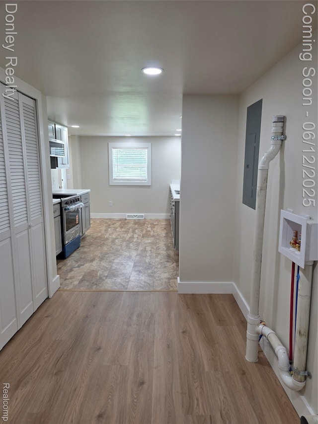 4514 Sebewaing Rd, Owendale, MI 48754 - kitchen with electric panel, electric stove, light wood-style flooring, light countertops, and recessed lighting