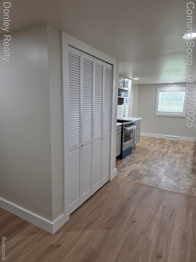 4514 Sebewaing Rd, Owendale, MI 48754 - kitchen featuring appliances with stainless steel finishes, light wood-style flooring, baseboards, and light countertops