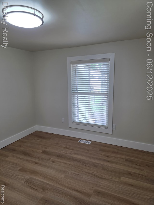 4514 Sebewaing Rd, Owendale, MI 48754 - unfurnished room featuring baseboards and dark wood-style flooring