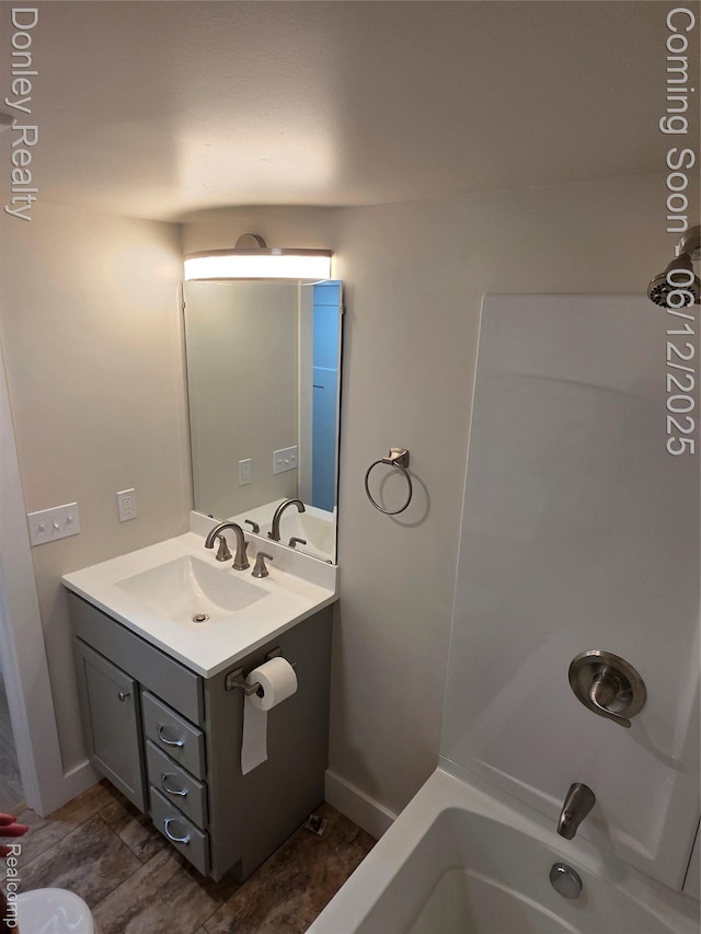 4514 Sebewaing Rd, Owendale, MI 48754 - full bath featuring vanity, bathtub / shower combination, and baseboards
