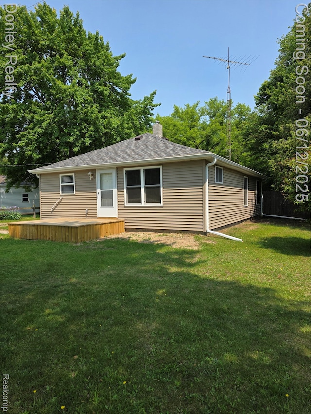 4514 Sebewaing Rd, Owendale, MI 48754 - rear view of property featuring a deck, a chimney, and a shingled roof