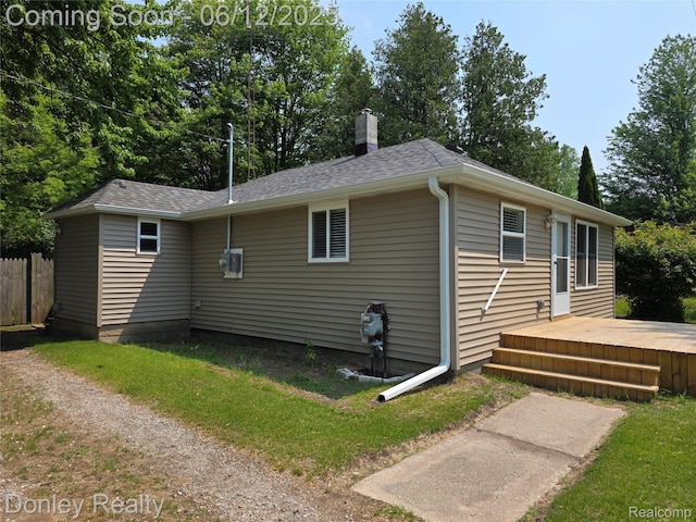 4514 Sebewaing Rd, Owendale, MI 48754 - view of property exterior featuring a wooden deck, a chimney, and roof with shingles
