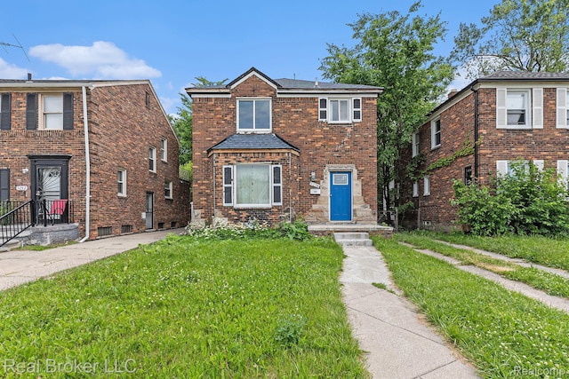 9236 Manistique St, Detroit, MI 48224 - traditional home with a front yard, roof with shingles, and brick siding