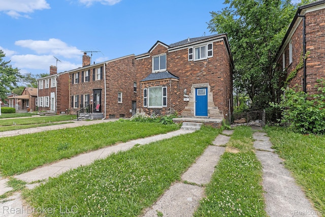 9236 Manistique St, Detroit, MI 48224 - multi unit property featuring a front yard, brick siding, and a chimney