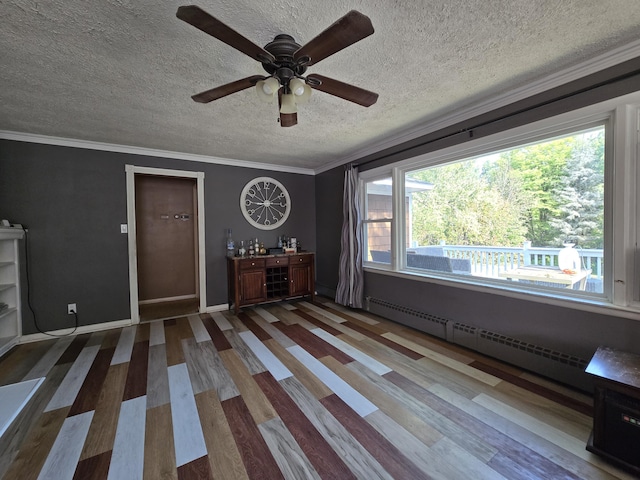 10017 M-115, Cadillac, MI 49601 - unfurnished bedroom featuring a baseboard heating unit, a textured ceiling, ornamental molding, wood finished floors, and a ceiling fan