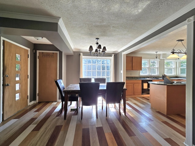 10017 M-115, Cadillac, MI 49601 - dining area featuring a chandelier, light wood-style floors, ornamental molding, and a textured ceiling