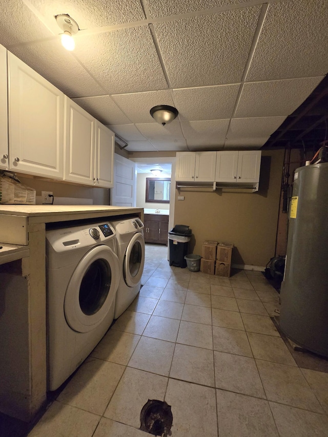 10017 M-115, Cadillac, MI 49601 - laundry area featuring separate washer and dryer, water heater, light tile patterned floors, and cabinet space