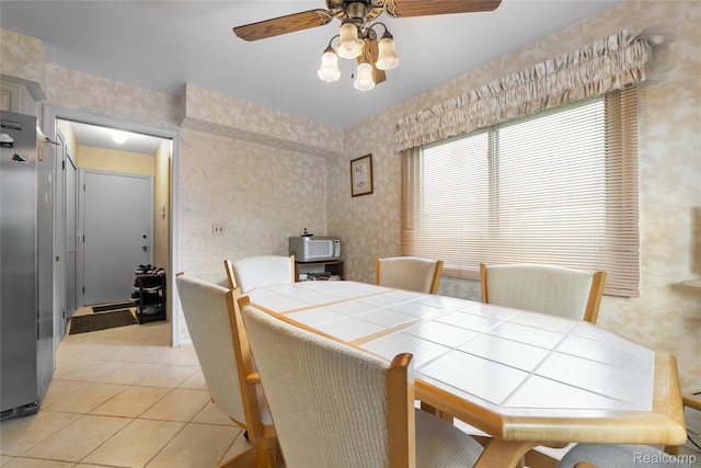 22840 Twyckingham Way, Addison, MI 48034 - dining area featuring a ceiling fan, wallpapered walls, and light tile patterned floors