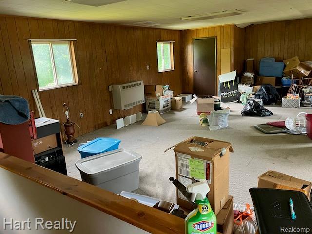 138 W Hunters Creek Rd, Lapeer, MI 48446 - living area featuring heating unit and wood walls