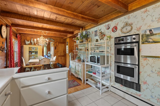 987 Wagner Dr, Battle Creek, MI 49017 - kitchen with wood ceiling with exposed beams, stainless steel appliances, light tile patterned floors, a chandelier, and wallpapered walls