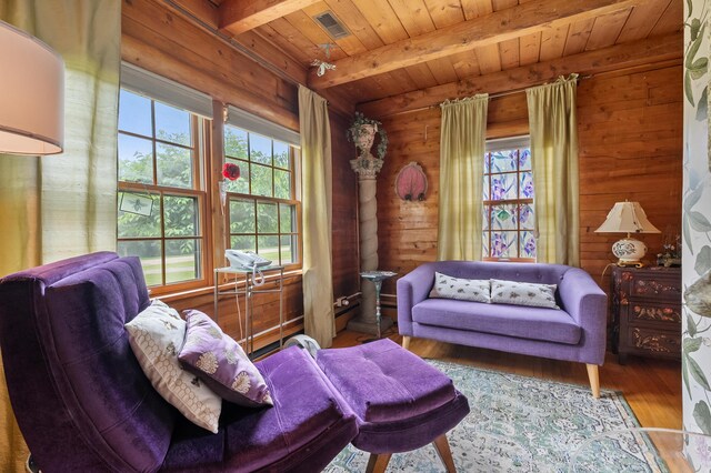 987 Wagner Dr, Battle Creek, MI 49017 - living room featuring plenty of natural light, wood ceiling with exposed beams, wooden walls, and wood finished floors