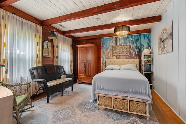 987 Wagner Dr, Battle Creek, MI 49017 - bedroom featuring wood finished floors, wooden walls, wood ceiling with exposed beams, and baseboards