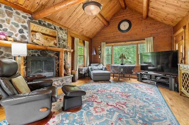 987 Wagner Dr, Battle Creek, MI 49017 - living area with wood walls, hardwood / wood-style flooring, wooden ceiling, a stone fireplace, and a baseboard radiator