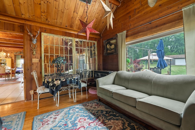 987 Wagner Dr, Battle Creek, MI 49017 - living room featuring wood walls, wooden ceiling, healthy amount of natural light, wood finished floors, and a chandelier
