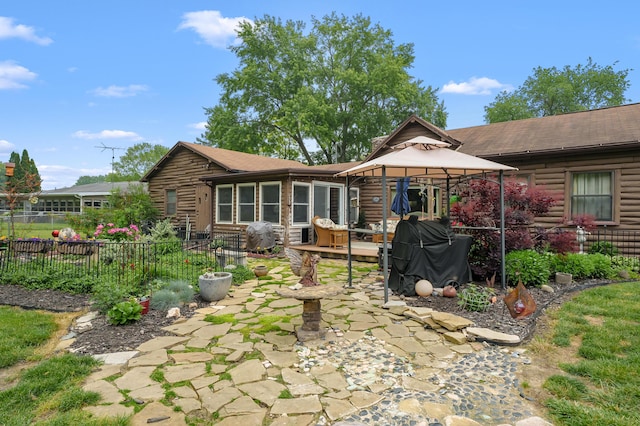987 Wagner Dr, Battle Creek, MI 49017 - rear view of property with a gazebo, a patio area, and log siding