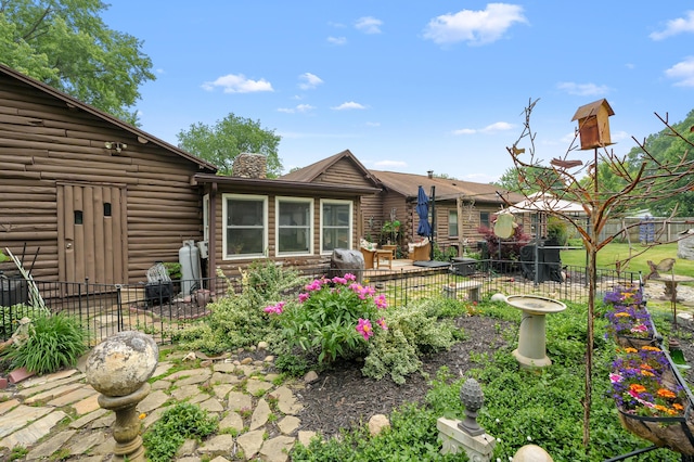 987 Wagner Dr, Battle Creek, MI 49017 - rear view of property with a chimney and log siding