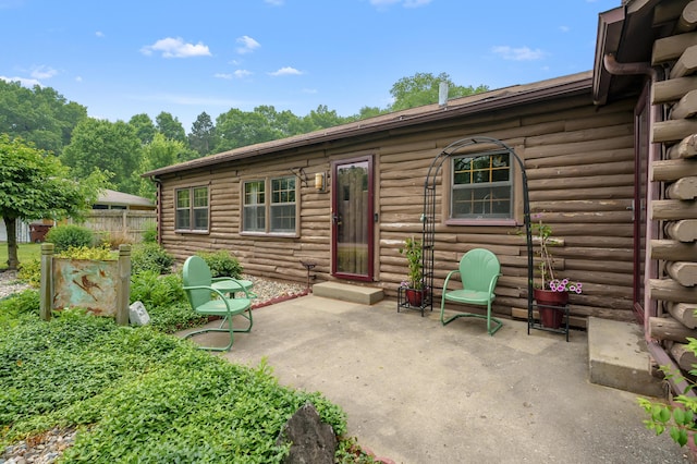 987 Wagner Dr, Battle Creek, MI 49017 - back of property with a patio and log siding