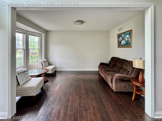 6038 Mayapple Dr, Troy, MI 48085 - living room featuring dark wood-style flooring and baseboards