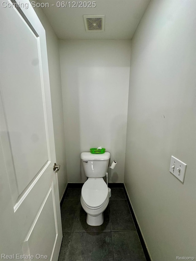 6038 Mayapple Dr, Troy, MI 48085 - bathroom featuring baseboards, tile patterned floors, and toilet