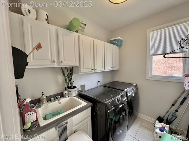 6038 Mayapple Dr, Troy, MI 48085 - laundry area featuring cabinet space, separate washer and dryer, light tile patterned floors, and baseboards