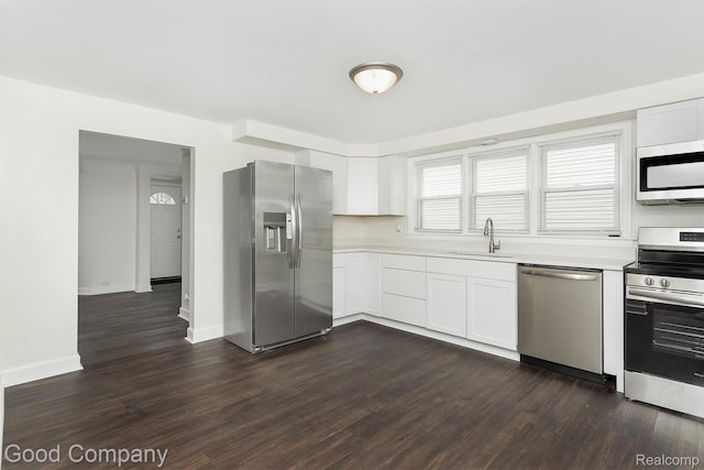 225 Euclid St, Mount Clemens, MI 48043 - kitchen featuring appliances with stainless steel finishes, light countertops, dark wood-style flooring, and white cabinetry