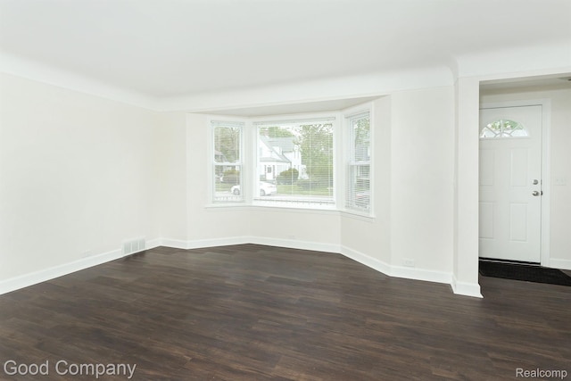 225 Euclid St, Mount Clemens, MI 48043 - unfurnished room with baseboards and dark wood-style floors
