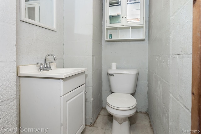 225 Euclid St, Mount Clemens, MI 48043 - half bathroom with vanity, toilet, tile patterned flooring, and concrete block wall