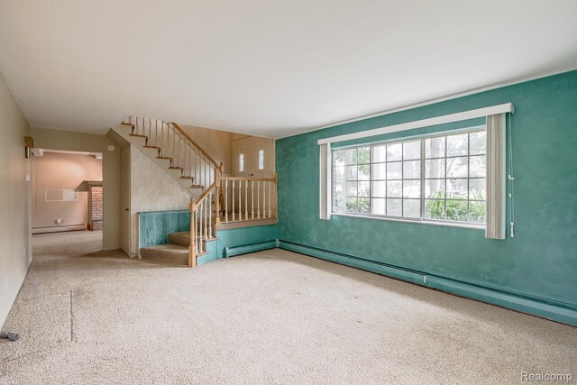 1231 Duckwood Ct, White Lake, MI 48383 - unfurnished living room with carpet, baseboard heating, and stairway