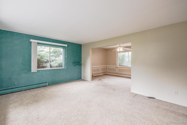 1231 Duckwood Ct, White Lake, MI 48383 - carpeted empty room with baseboard heating, a ceiling fan, and a baseboard heating unit