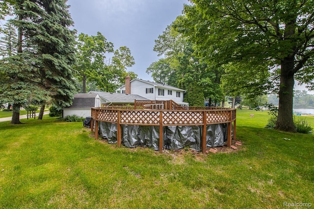 1231 Duckwood Ct, White Lake, MI 48383 - rear view of house with a wooden deck and a yard