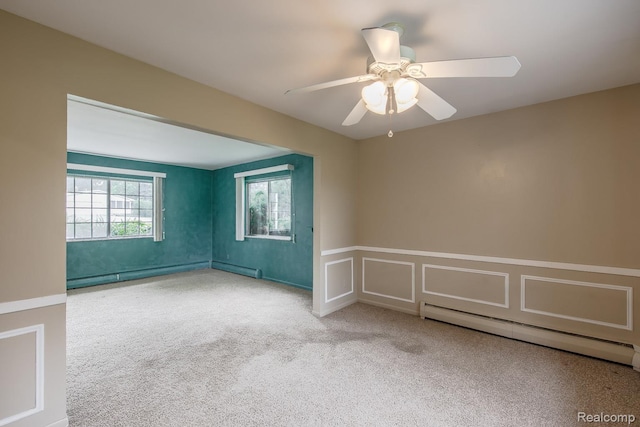 1231 Duckwood Ct, White Lake, MI 48383 - carpeted spare room with baseboard heating, a wainscoted wall, a baseboard radiator, ceiling fan, and a decorative wall