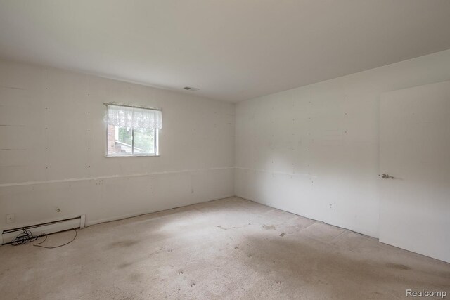 1231 Duckwood Ct, White Lake, MI 48383 - carpeted spare room with a baseboard heating unit