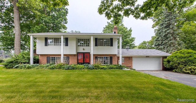 1231 Duckwood Ct, White Lake, MI 48383 - view of front of home with brick siding, a front lawn, asphalt driveway, and a garage