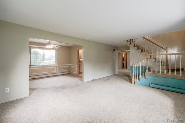 1231 Duckwood Ct, White Lake, MI 48383 - unfurnished living room featuring a baseboard radiator, carpet, and stairs