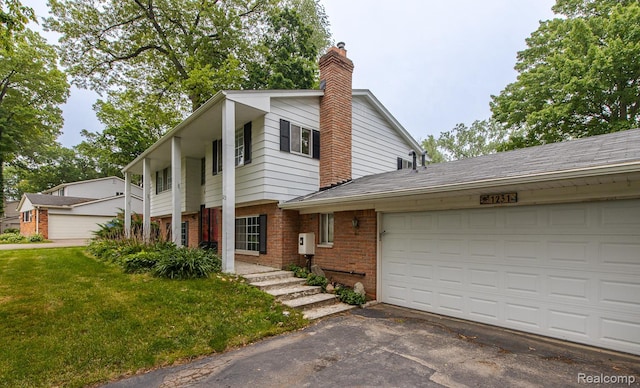 1231 Duckwood Ct, White Lake, MI 48383 - view of front of house with brick siding, a chimney, asphalt driveway, a front lawn, and a garage