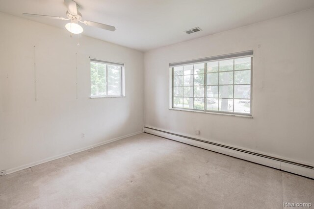1231 Duckwood Ct, White Lake, MI 48383 - empty room with a baseboard heating unit, carpet flooring, and ceiling fan