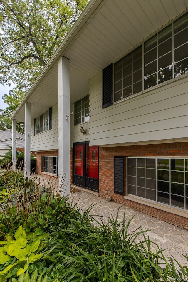 1231 Duckwood Ct, White Lake, MI 48383 - rear view of house featuring brick siding