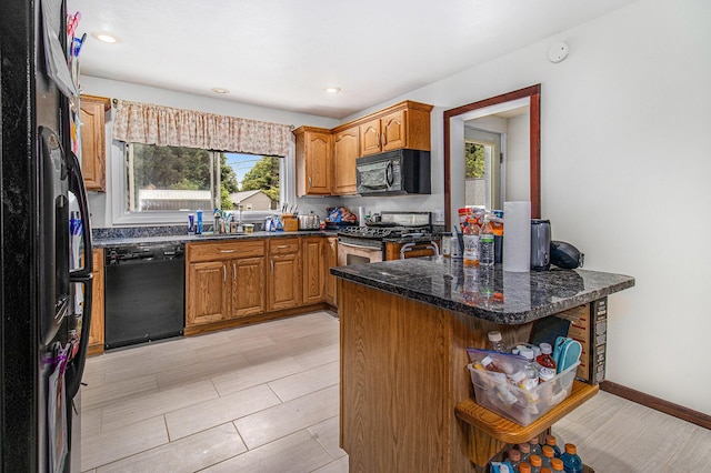 512 Clark St, Big Rapids, MI 49307 - kitchen with black appliances, open shelves, brown cabinetry, dark stone counters, and recessed lighting
