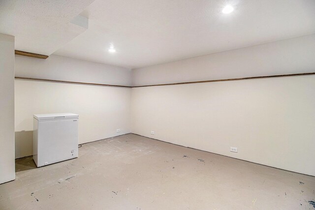 512 Clark St, Big Rapids, MI 49307 - finished below grade area featuring white refrigerator and recessed lighting