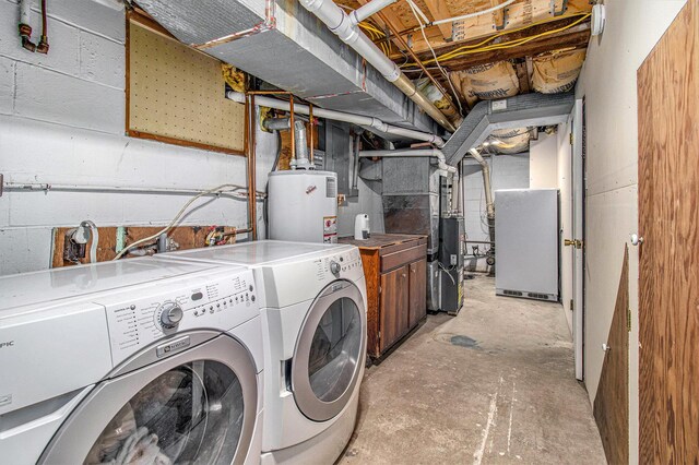 512 Clark St, Big Rapids, MI 49307 - laundry room featuring water heater, washing machine and clothes dryer, heating unit, and cabinet space