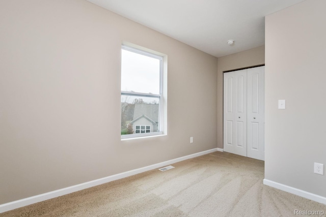 2099 Stillwater Dr, Davison, MI 48423 - unfurnished bedroom featuring baseboards, a closet, and carpet
