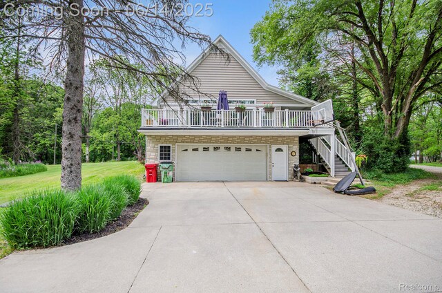 61995 Mount Vernon Rd, Washington, MI 48094 - view of front of house with stone siding, concrete driveway, stairway, and a garage