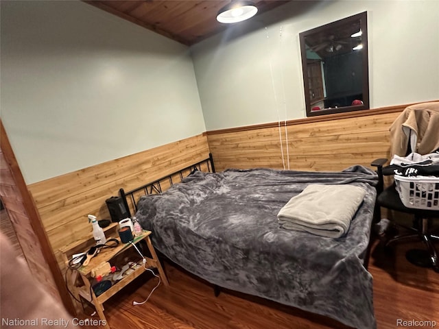5150 Lafave Rd, Black River, MI 48721 - bedroom with wainscoting, wooden walls, and wood finished floors
