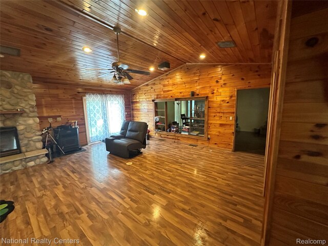 5150 Lafave Rd, Black River, MI 48721 - living area featuring wooden walls, wood finished floors, wood ceiling, lofted ceiling, and a fireplace